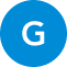 Ein weißer Großbuchstabe "G" ist auf einem einfarbig blauen, kreisförmigen Hintergrund zentriert.